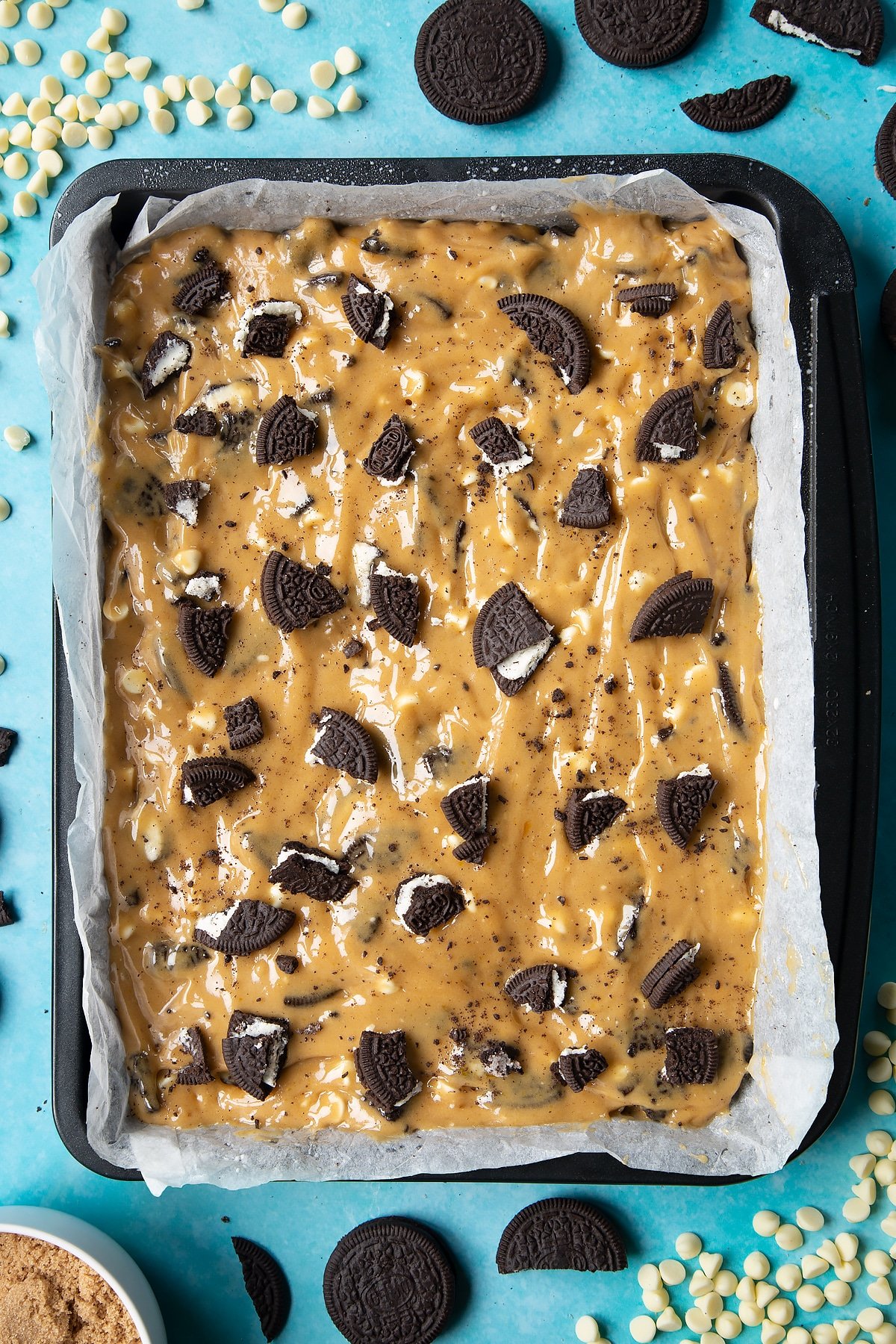 Overhead shot of Oreo Blondies batter mix in a lined baking tray