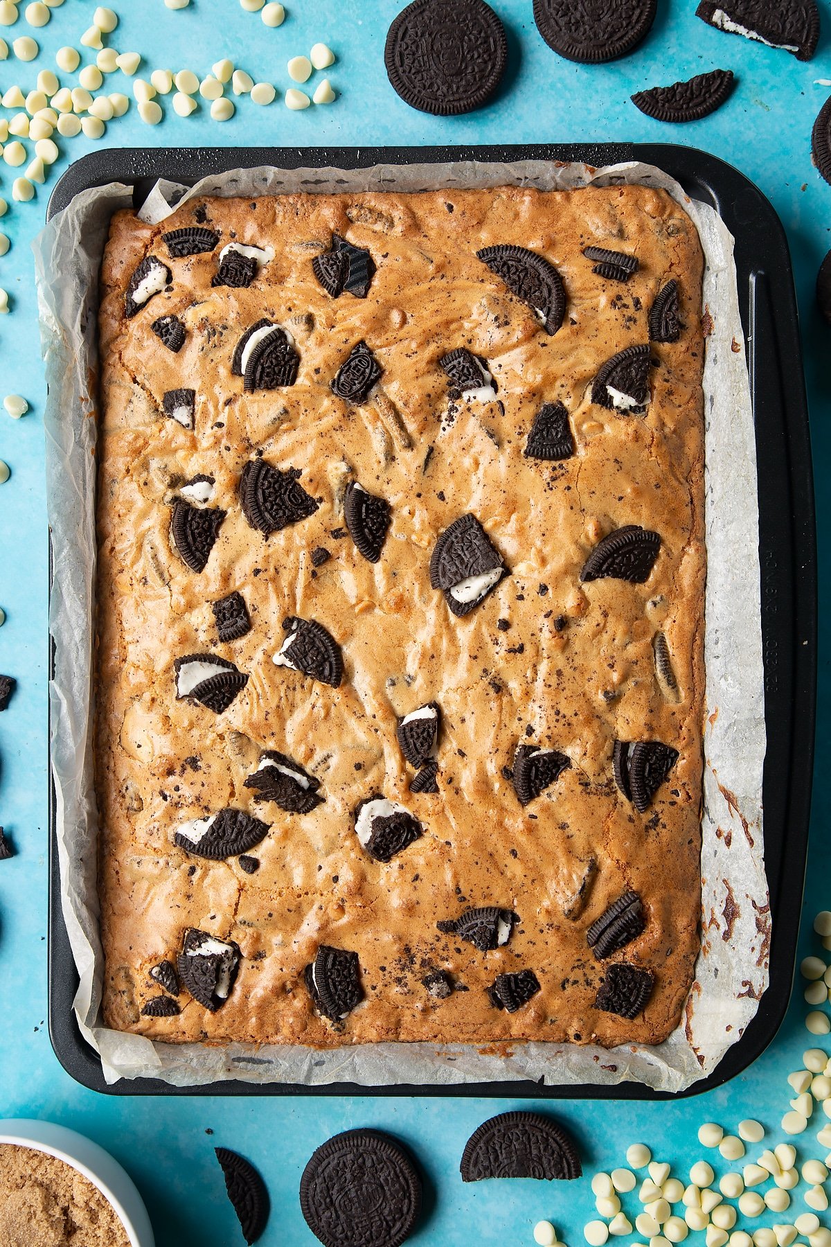 Overhead shot of baked Oreo Blondie in a lined baking tray