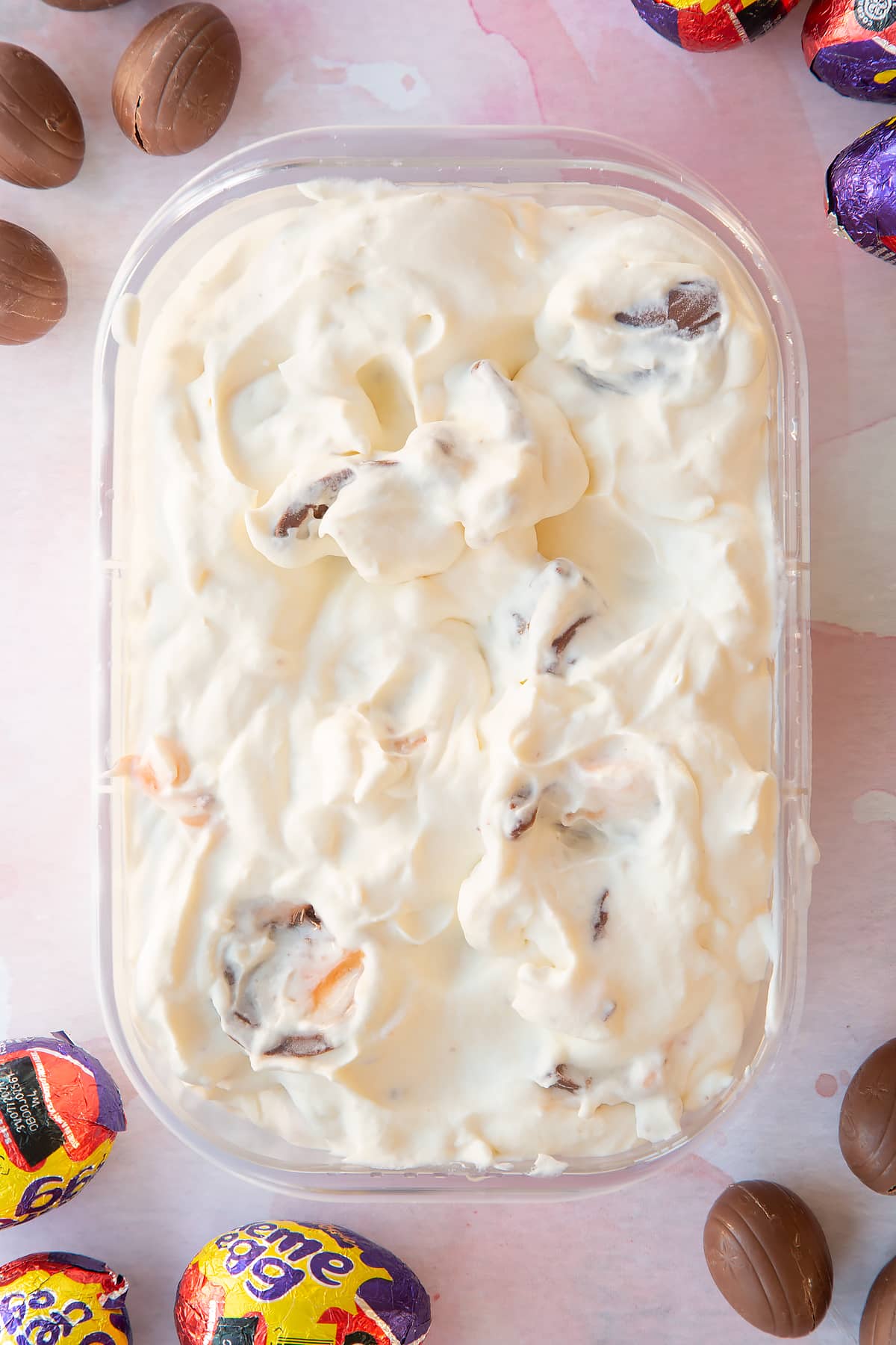 Creme Egg ice cream mixture in an oblong container.