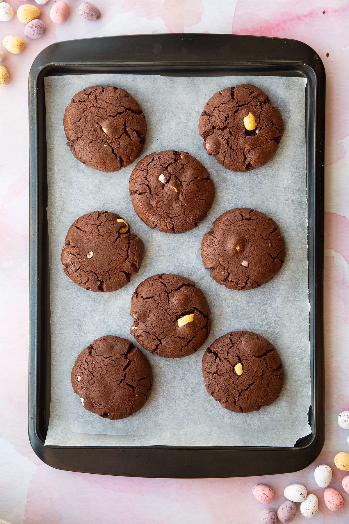 Chocolate Easter cookies on a tray lined with baking paper.