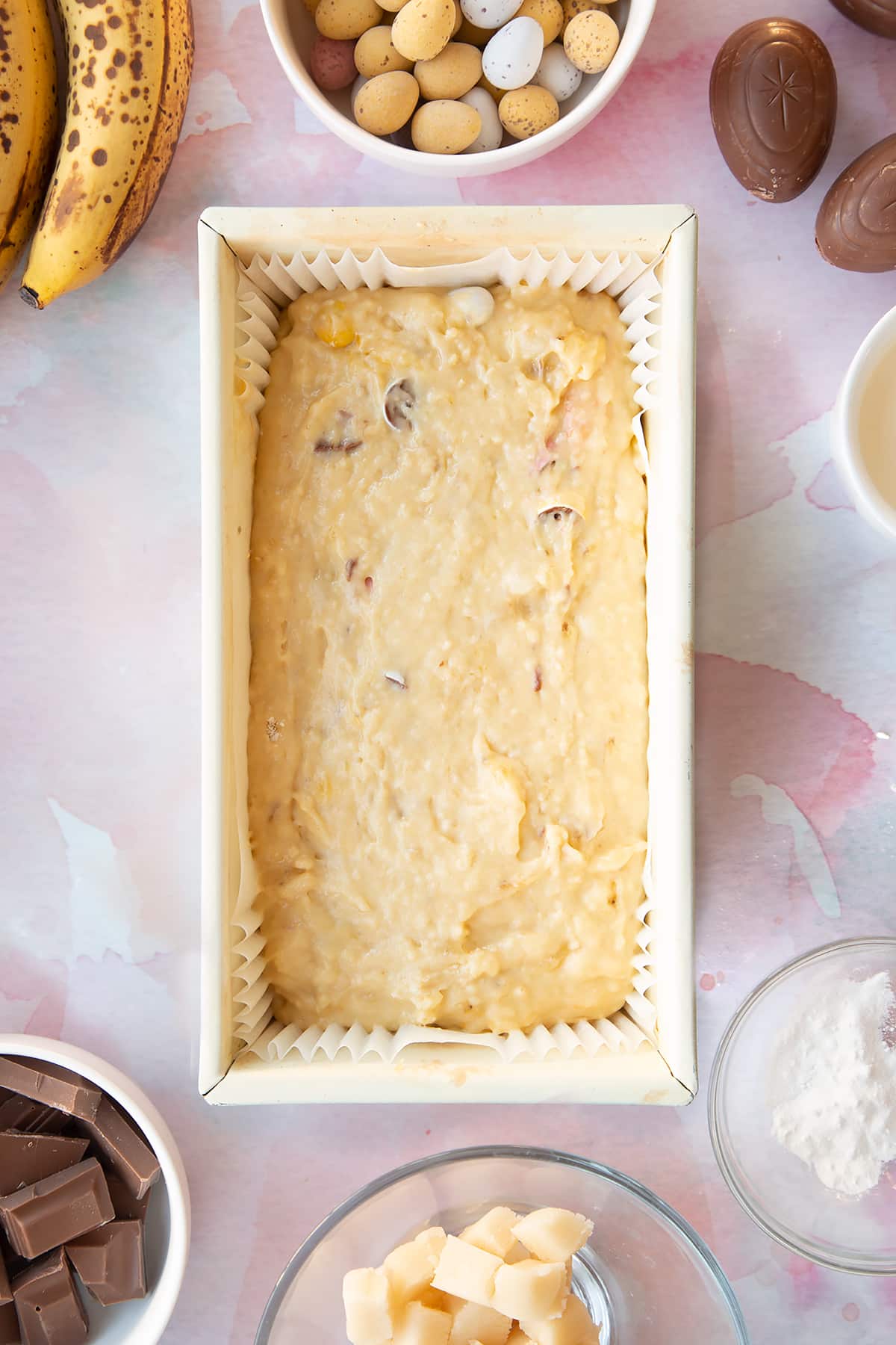 Easter banana bread batter in a lined tin.