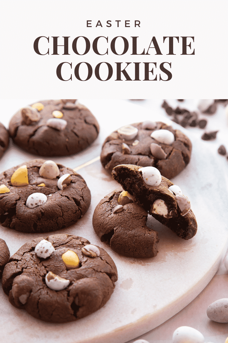 Chocolate Easter cookies arranged on a round marble board with one broken in half. Caption reads: Easter chocolate cookies