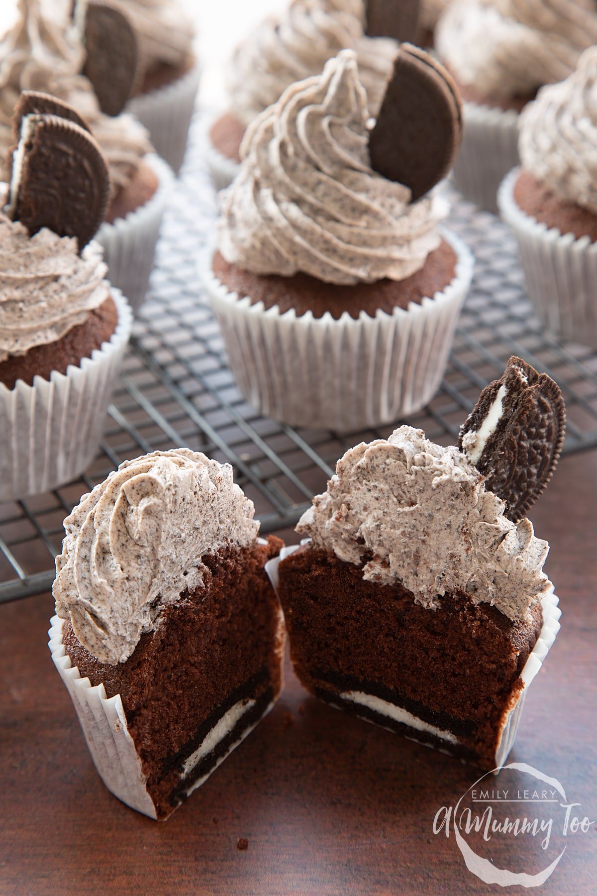 Front view shot of a chocolate cupcake with orea frosting cut in half