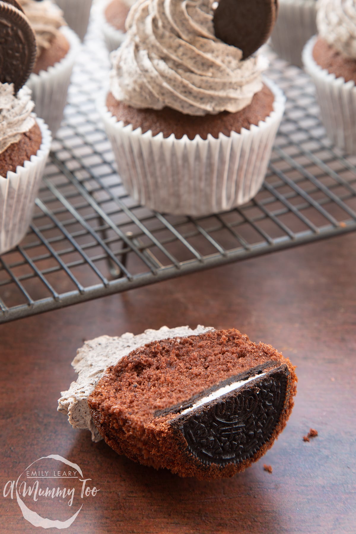 Front view shot of half a chocolate cupcake with oreo buttercream