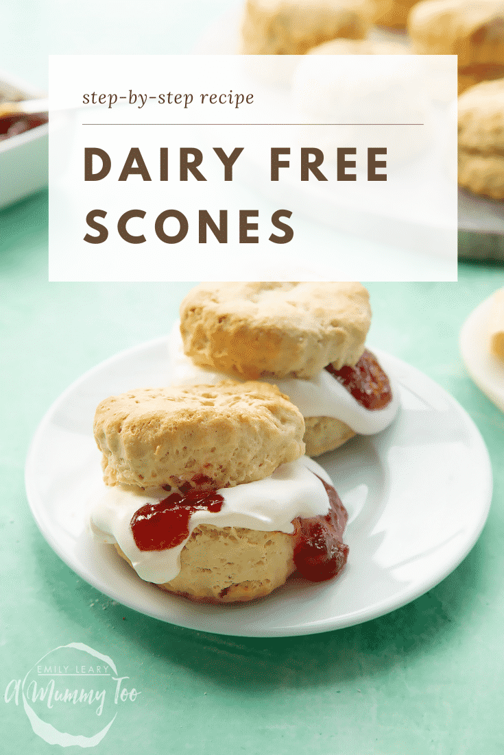 Two dairy free scones on a white plate. They are filled with jam and vegan whipped cream. Caption reads: step-by-step recipe dairy free scones