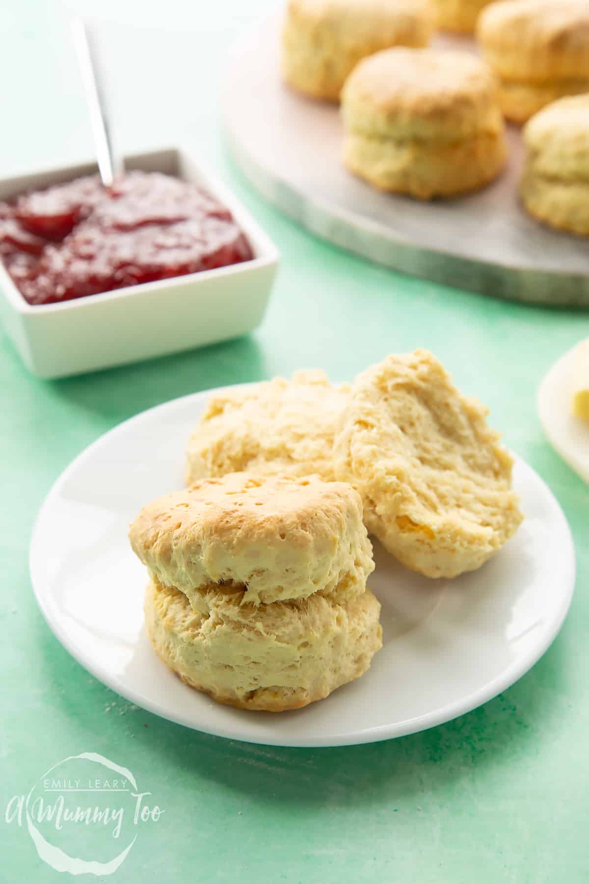 Two dairy free scones on a white plate.