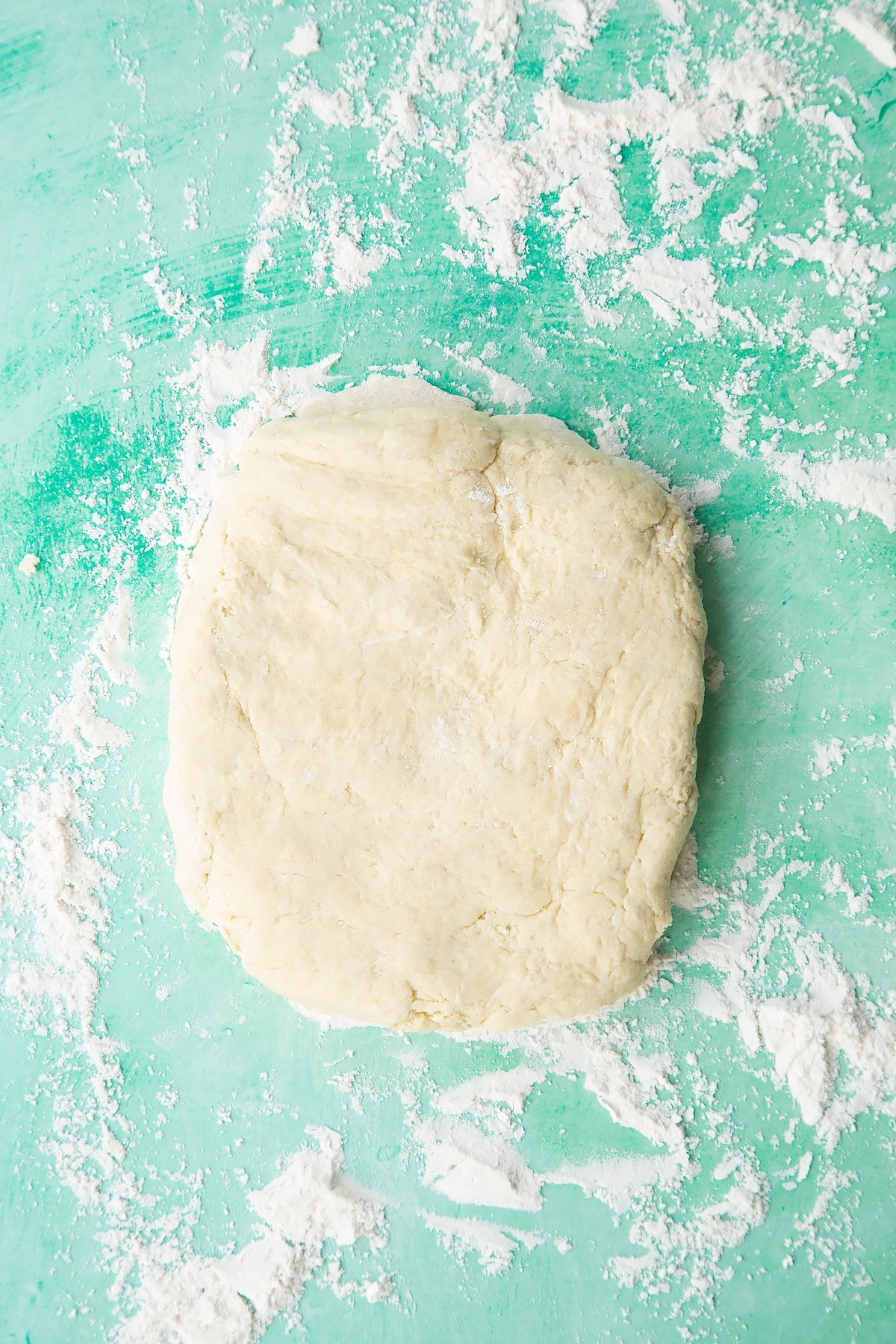 Dairy free scone dough pressed into a rectangle on a floured surface.