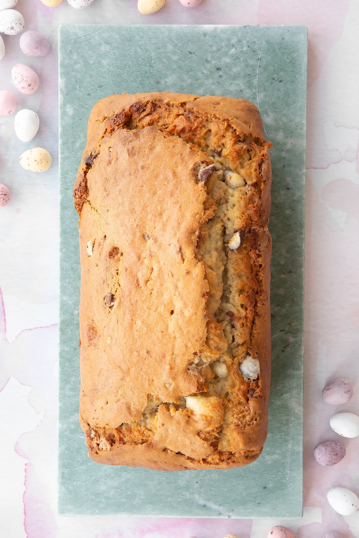 Easter banana bread on a long grey marble board.