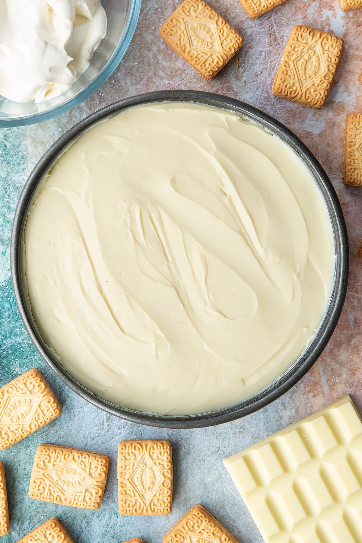 Overhead shot of white chocolate cream cheese mix in a large cake tin