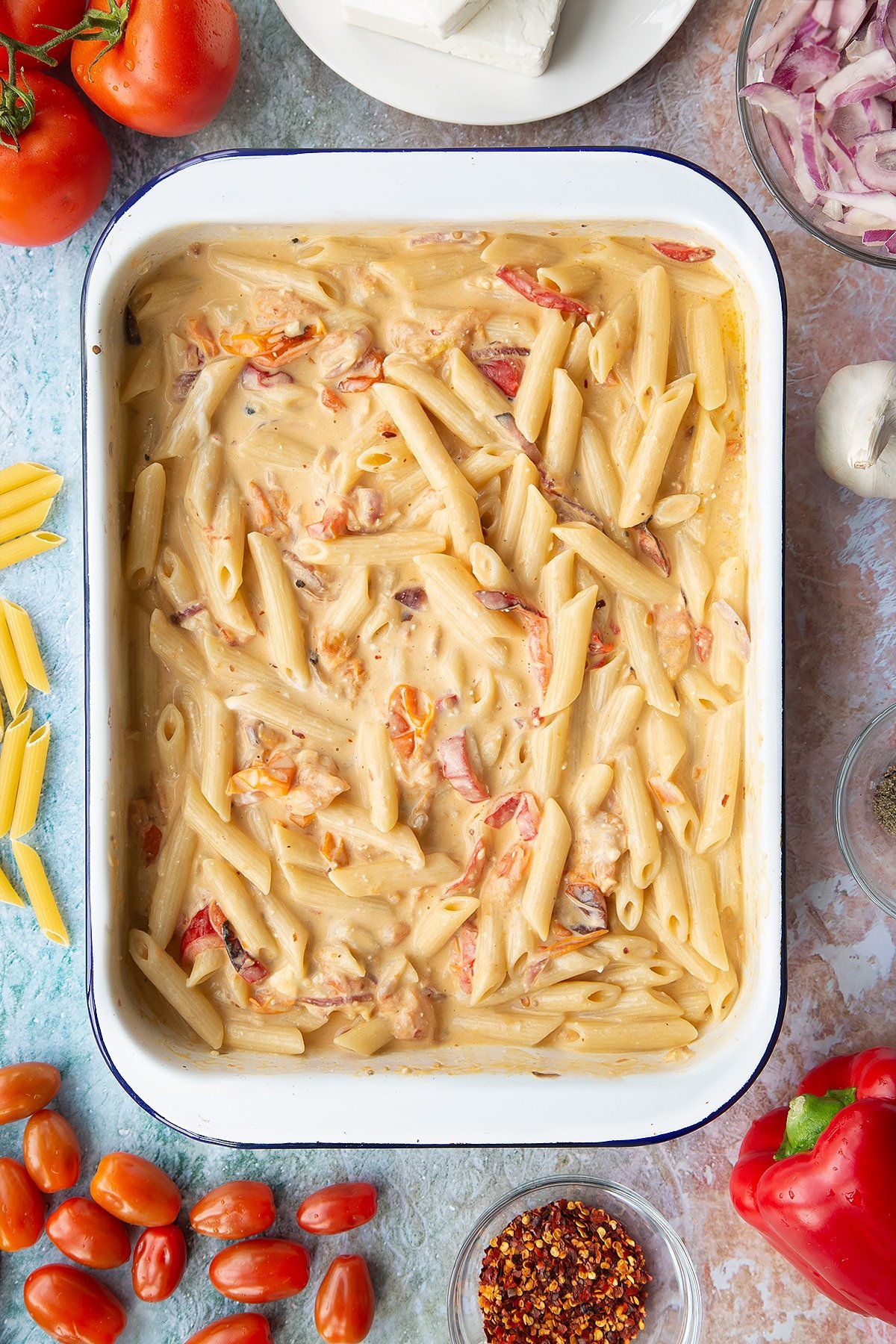 Baked feta pasta in a white tray.