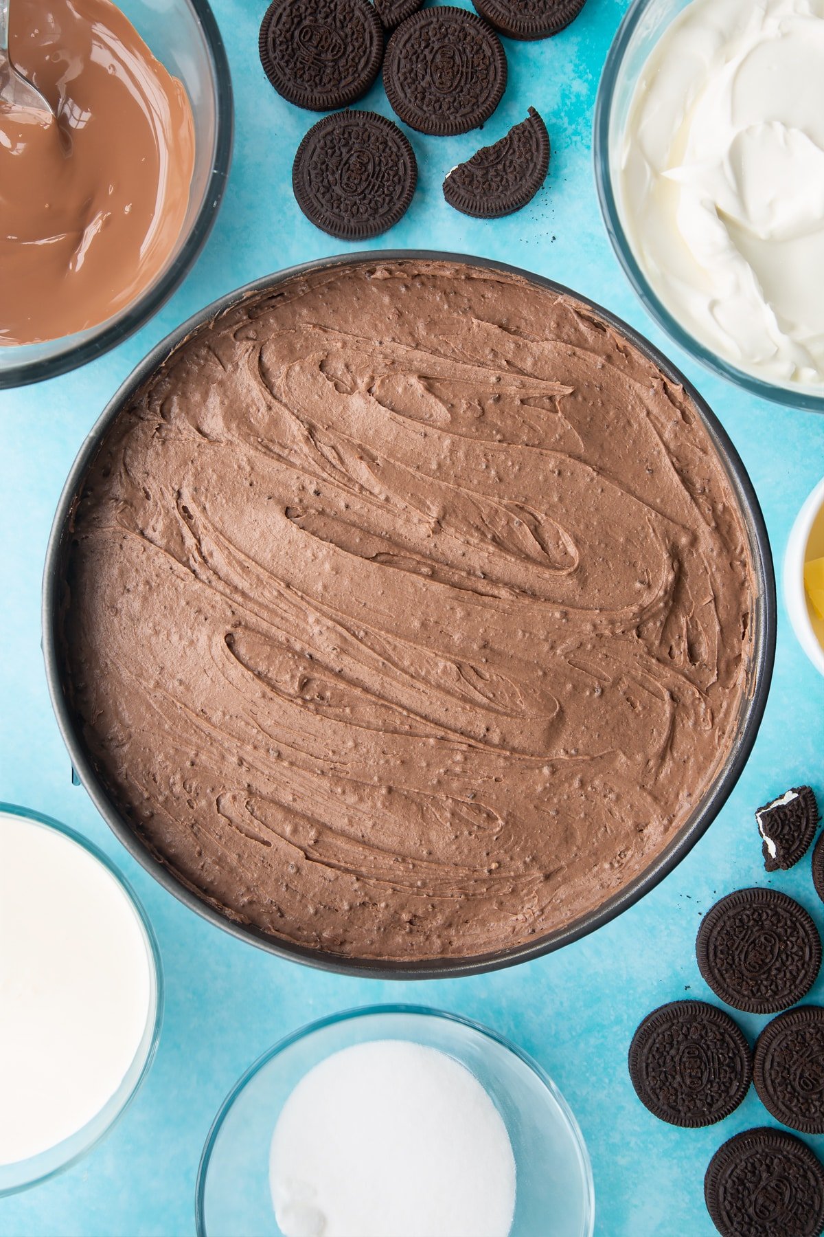 Overhead shot of whipped cheesecake topping in a large cake tin