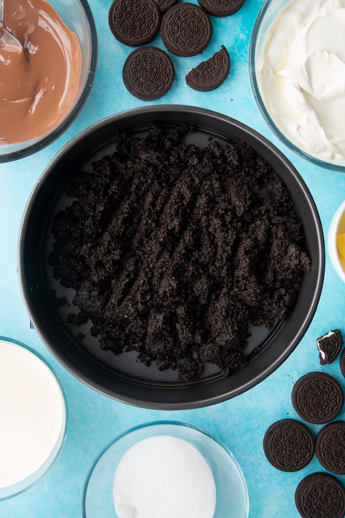 Overhead shot of oreo biscuits crumb in a large cake tin