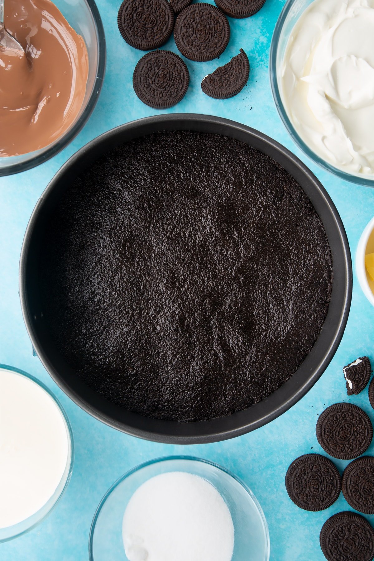 Overhead shot of oreo biscuits crumb pressed down in a large cake tin