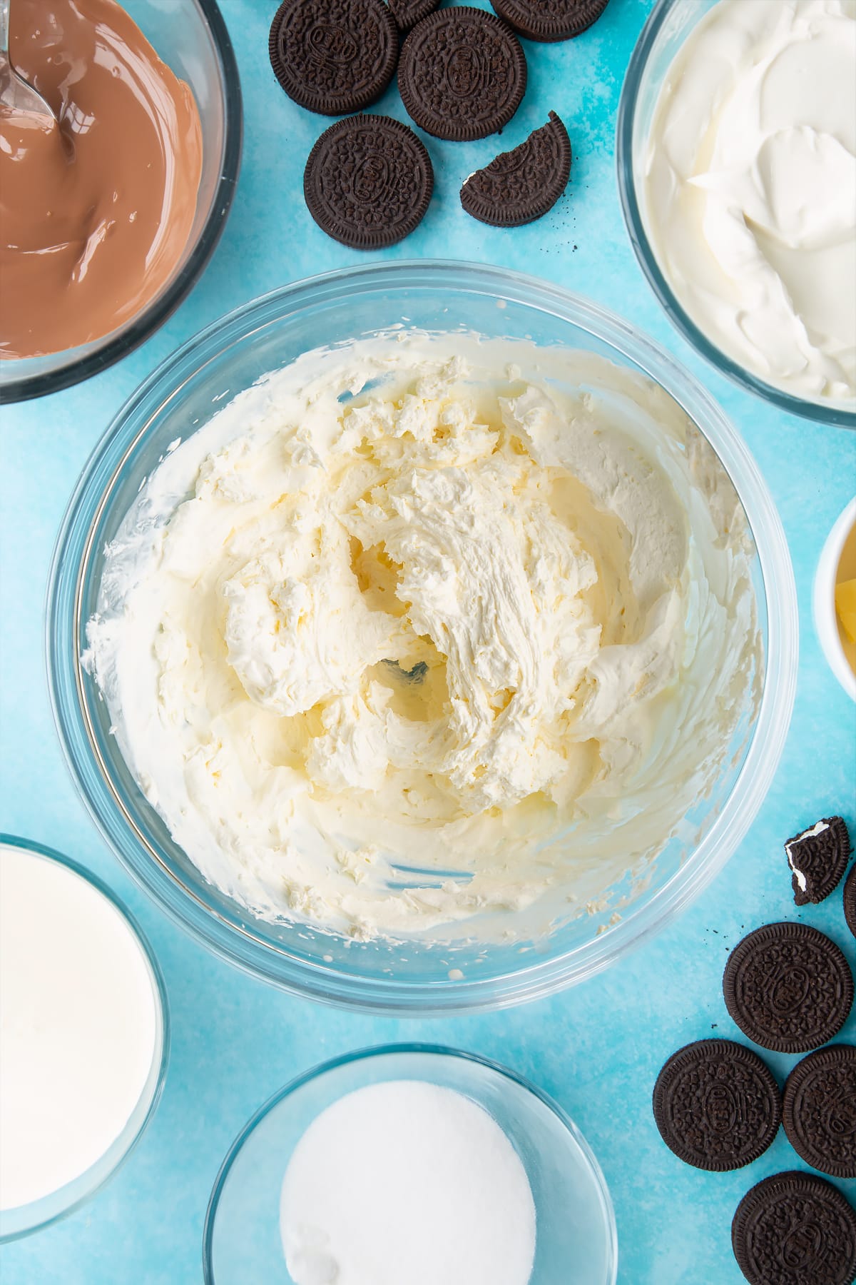 Overhead shot of cream whipped in a large clear bowl