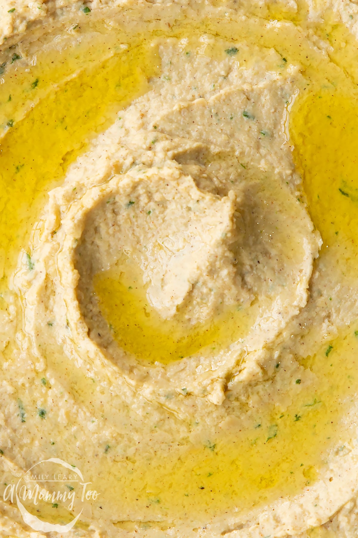 Cinnamon hummus from above in close up. It has been drizzled with olive oil