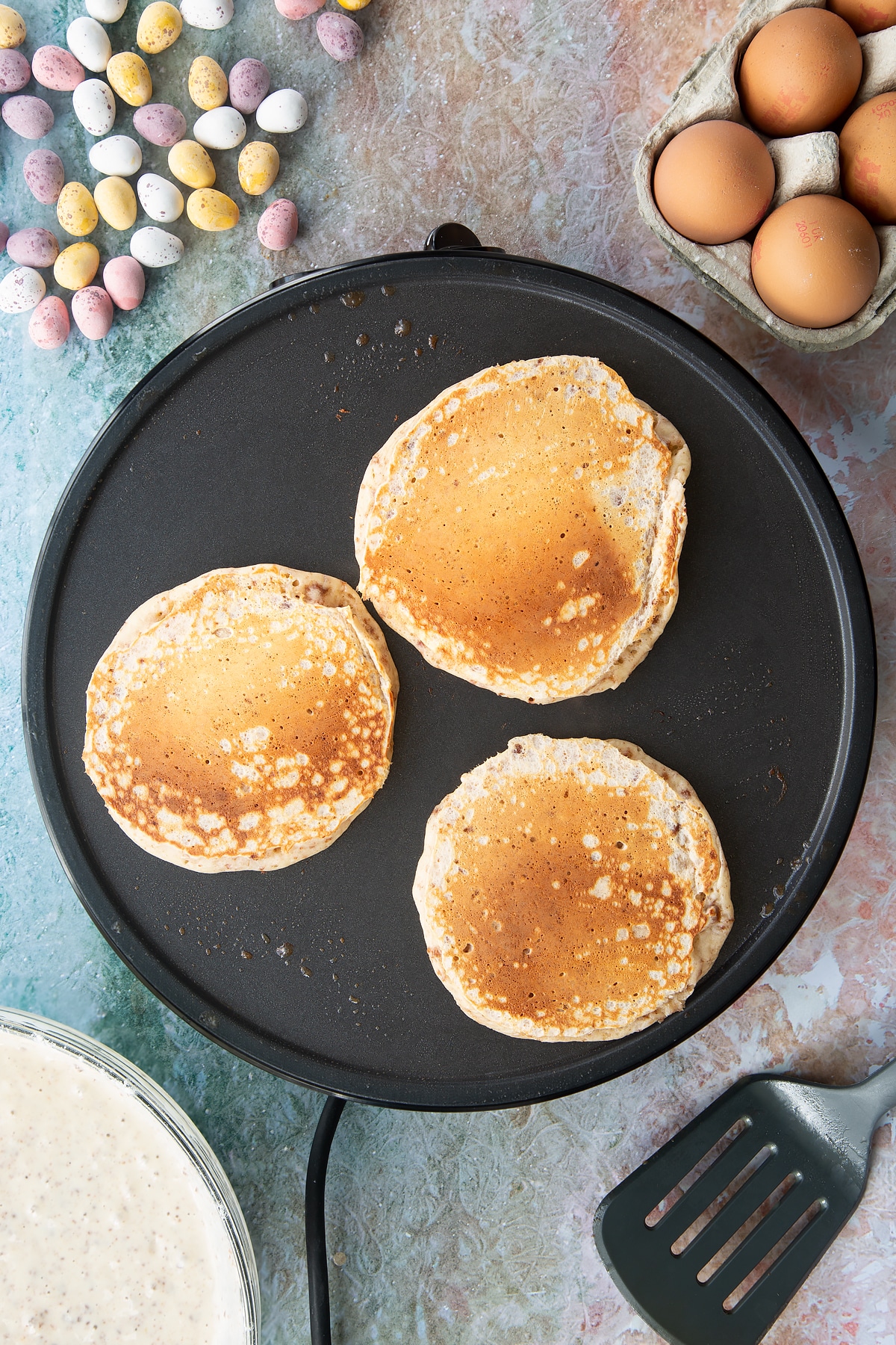 Freshly cooked Mini Egg pancakes on a hot pan. 