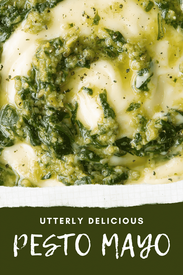 Close up of pesto mayo in a white bowl. The pesto and mayonnaise are swirled together. Caption: utterly delicious pesto mayo