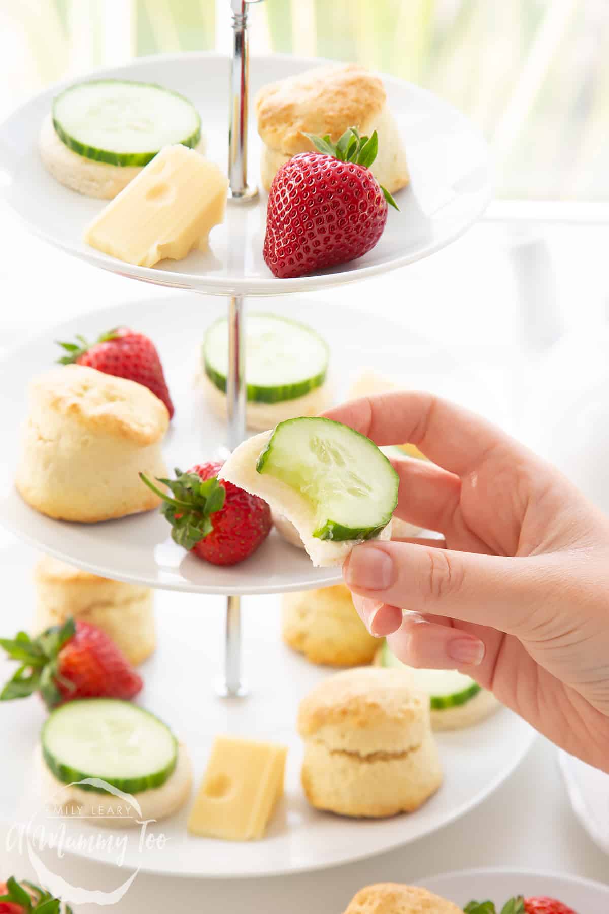 Hand holding a cucumber sandwhich from the Tom and Jerry afternoon tea.