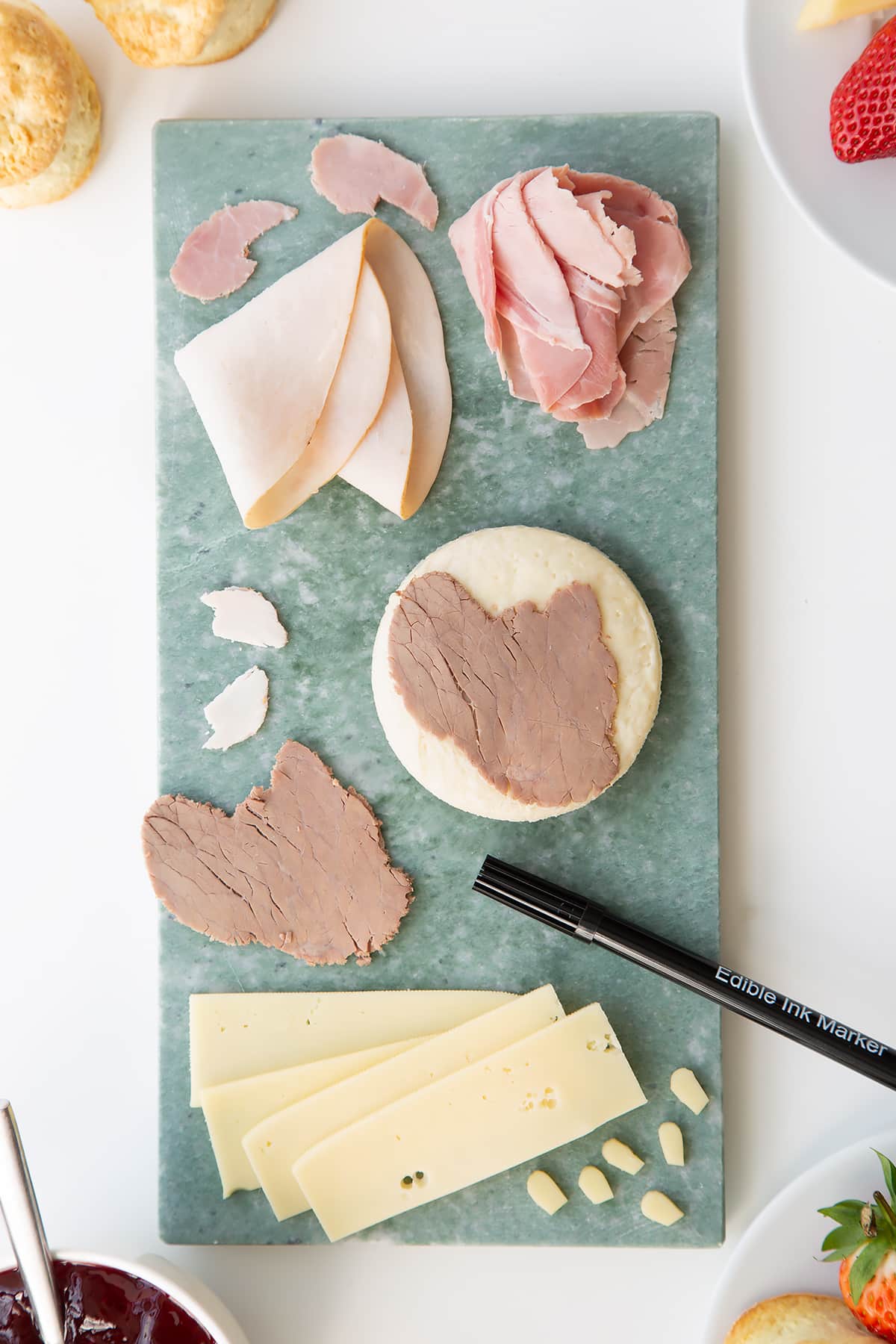 Overhead shot of the ingredients being assembled to make a Tom and Jerry sandwhich. 