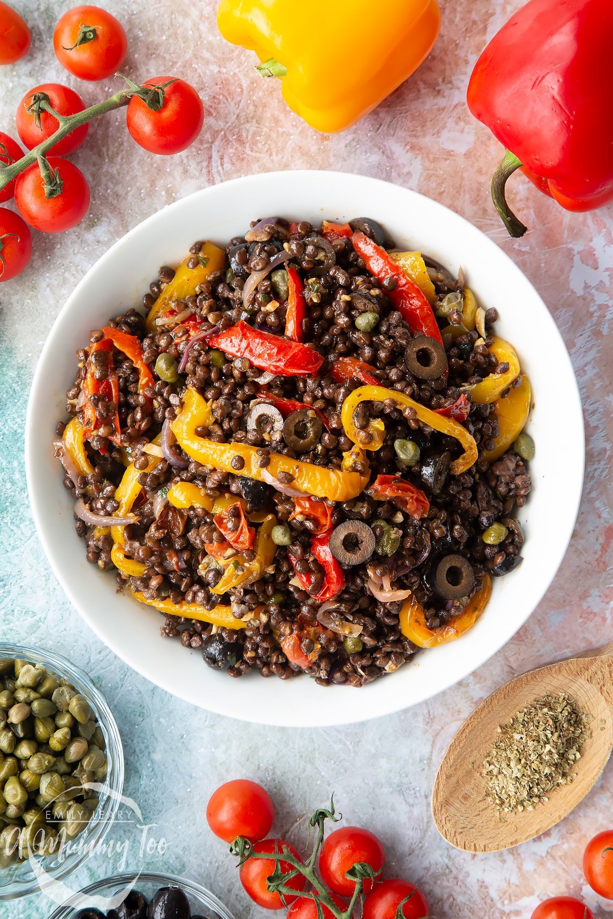 Vegan lentil salad served in a white shallow bowl, shown from above.