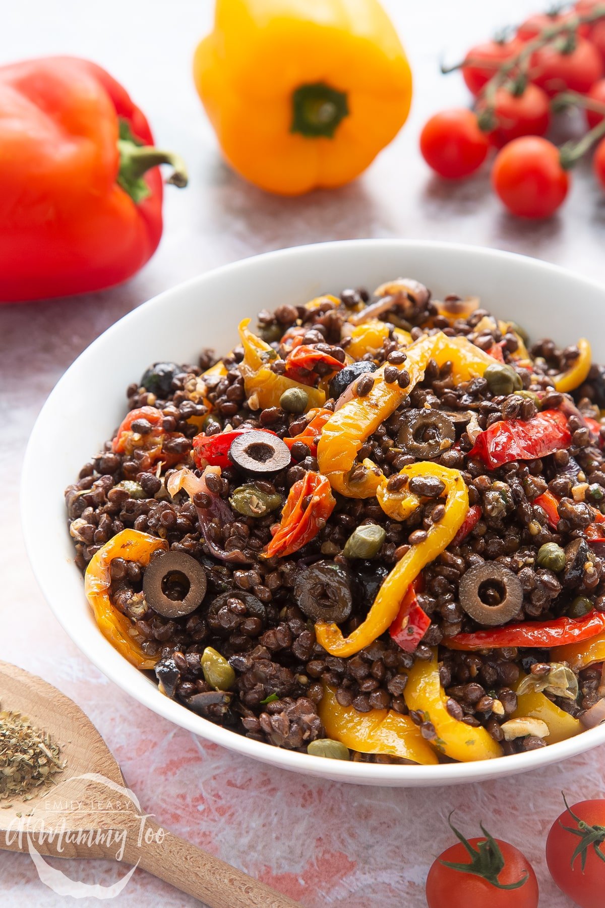 Vegan lentil salad served in a white shallow bowl.