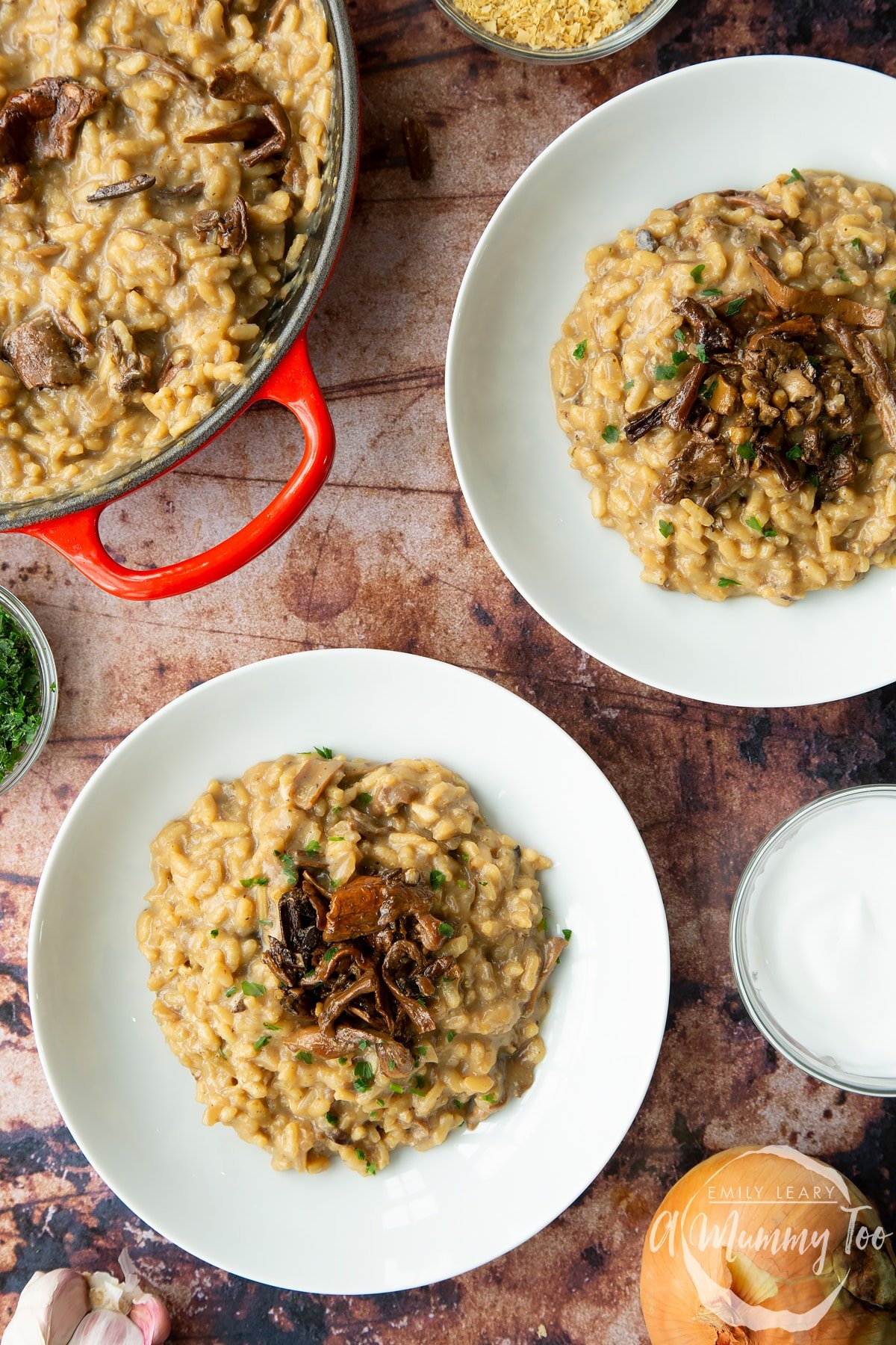 Vegan mushroom risotto in two shallow white bowls, shown from above.