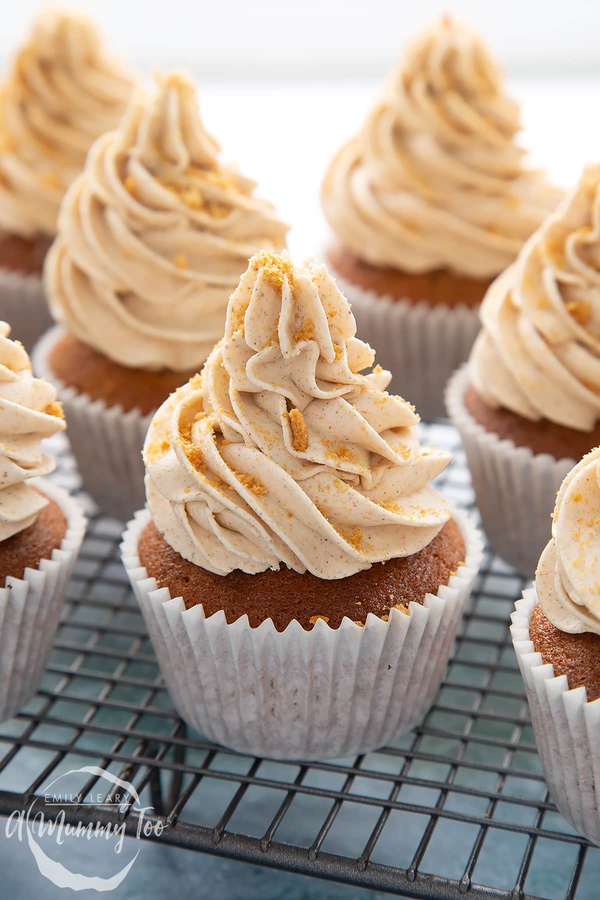 Ginger cupcakes on a wire rack.