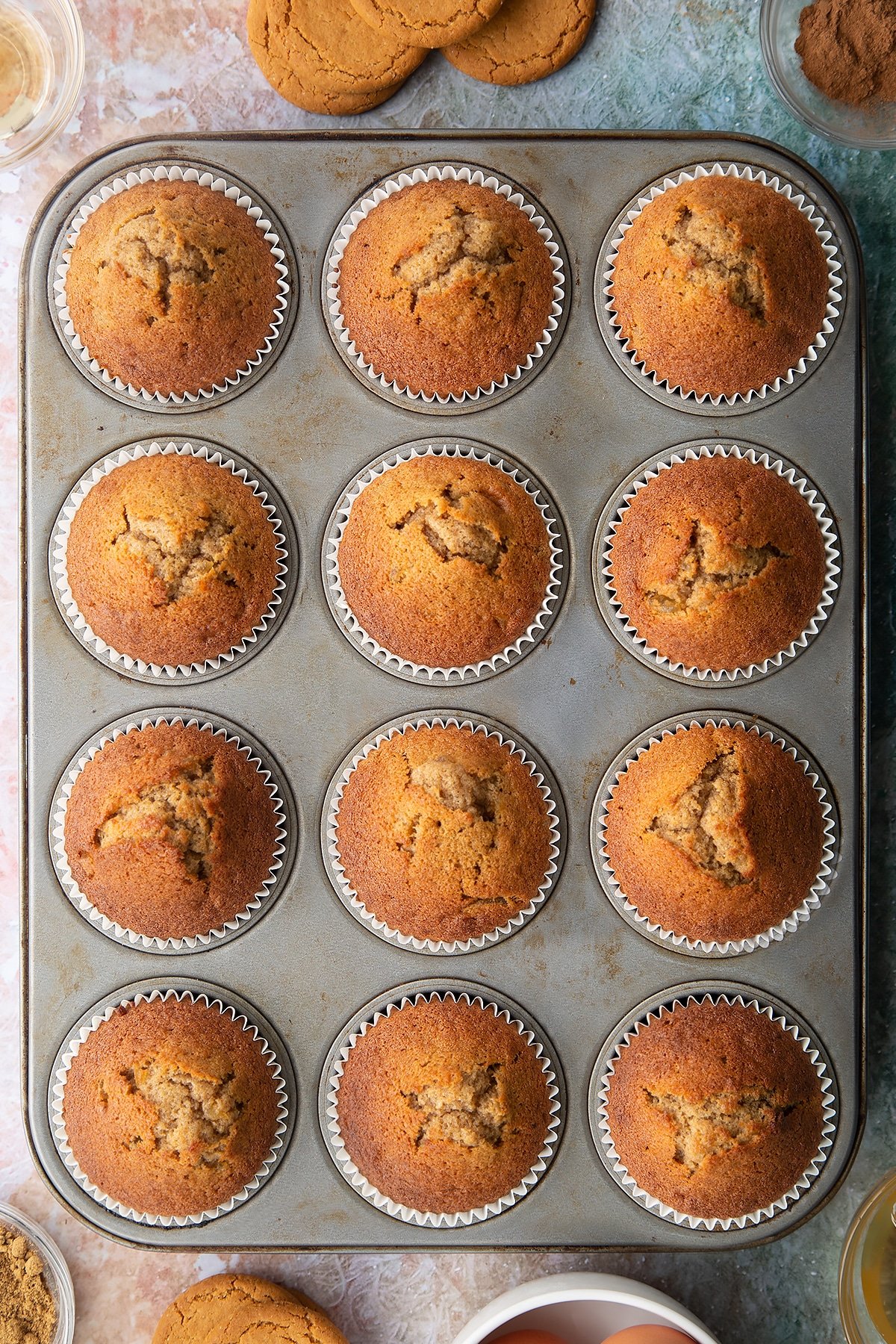 Ginger cupcakes freshly baked in a muffin tin.