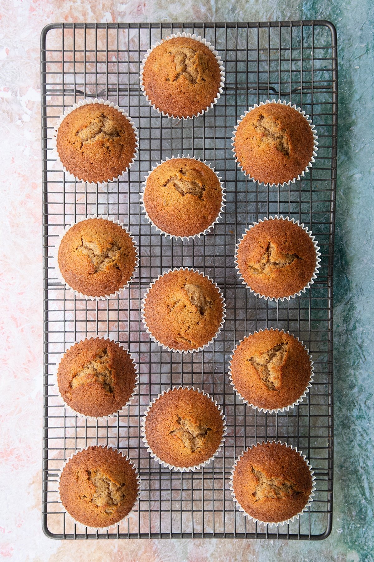 Freshly baked ginger cupcakes on a cooling rack.