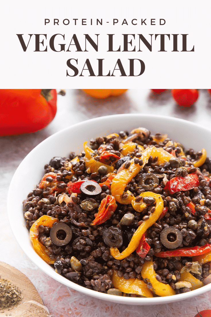 Vegan lentil salad served in a white shallow bowl. Caption reads: protein packed vegan lentil salad