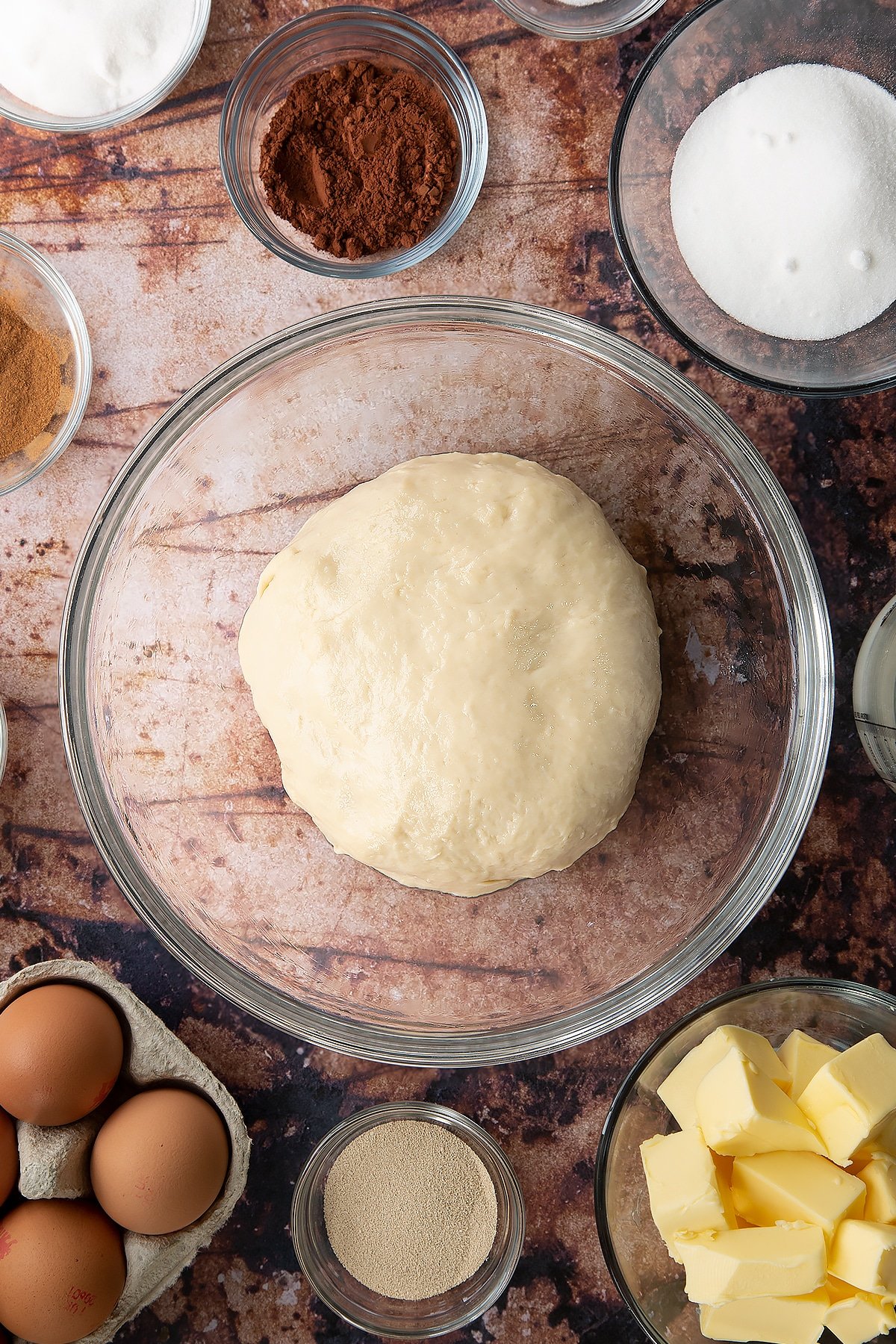 Overhead shot of bread dough in a large clear bowl.