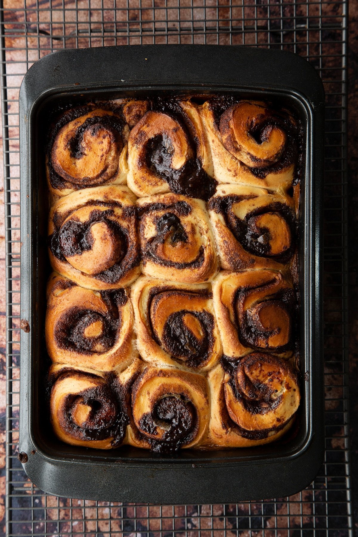 Overhead shot of chocolate cinnamon buns baked in a deep dish 