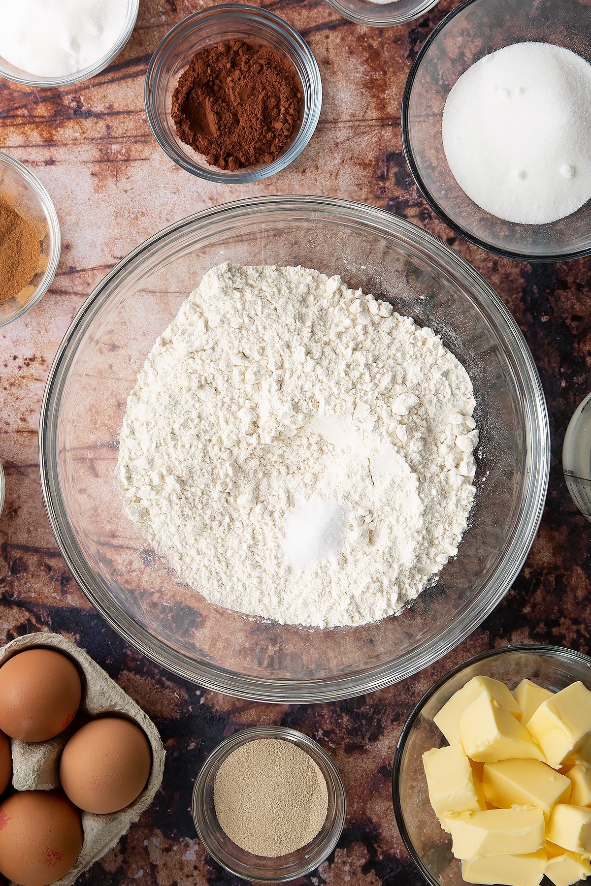 Overhead shot of flour and salt in a large clear bowl