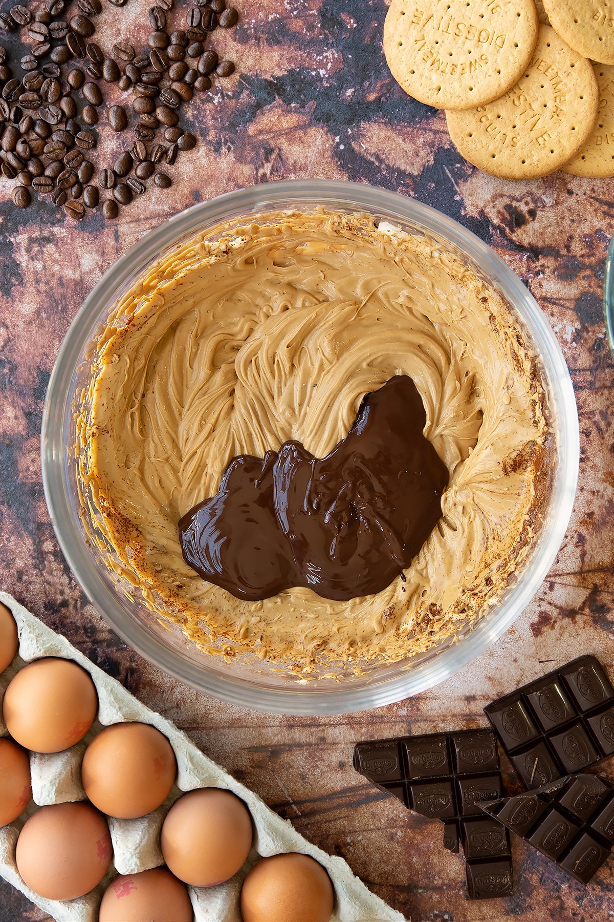 Overhead shot of the coffee and cream mix with melted chocolate in a large clear bowl