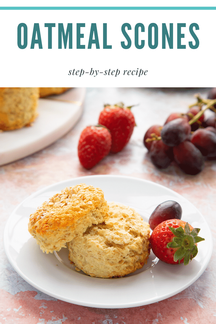 Oatmeal scone on a white plate. It has been split. Caption reads: Oatmeal Scones step-by-step recipe