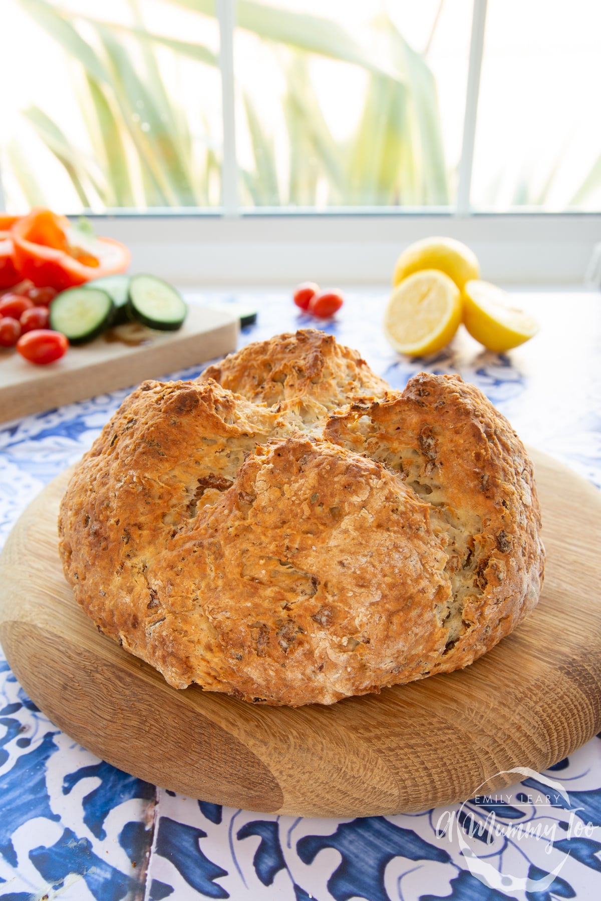 A loaf of onion soda bread on a wooden board.