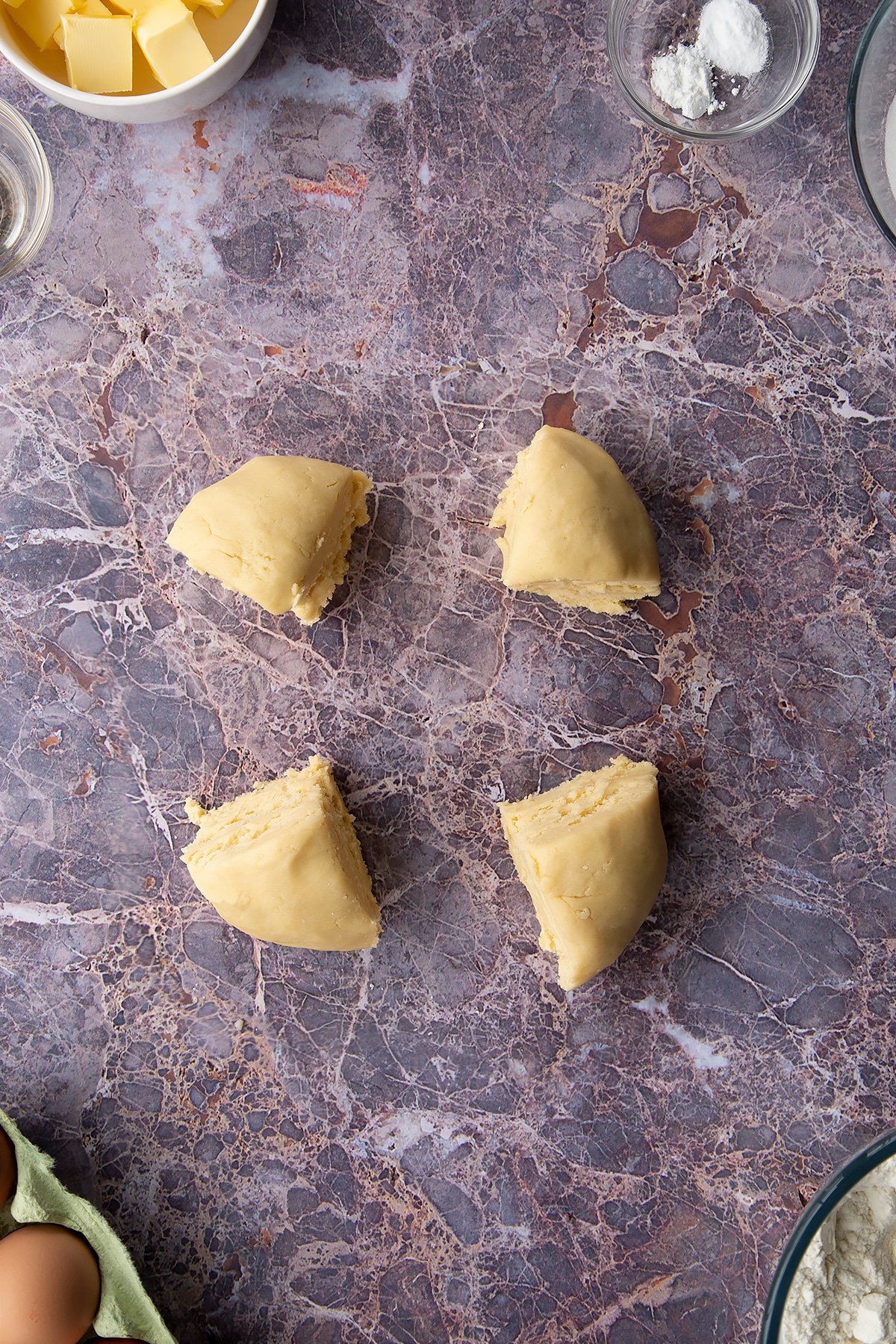 Overhead shot of cookie dough mixture cut into four pieces