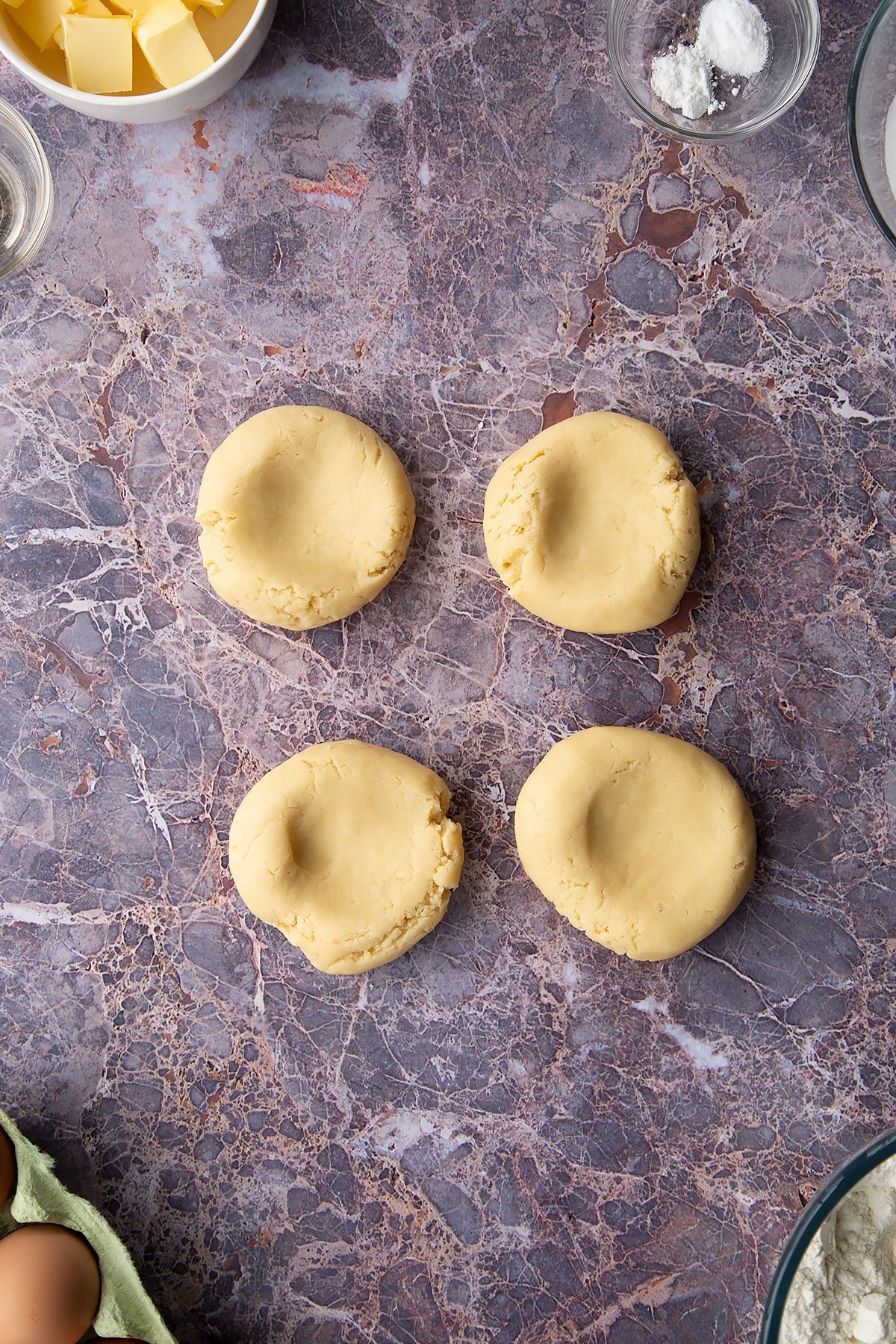 Overhead shot of cookie dough into four circular balls