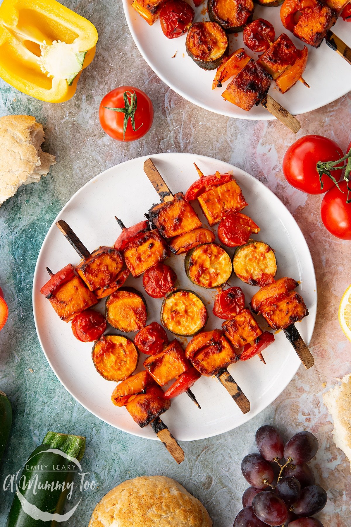 Tofu skewers arranged on a white plate.