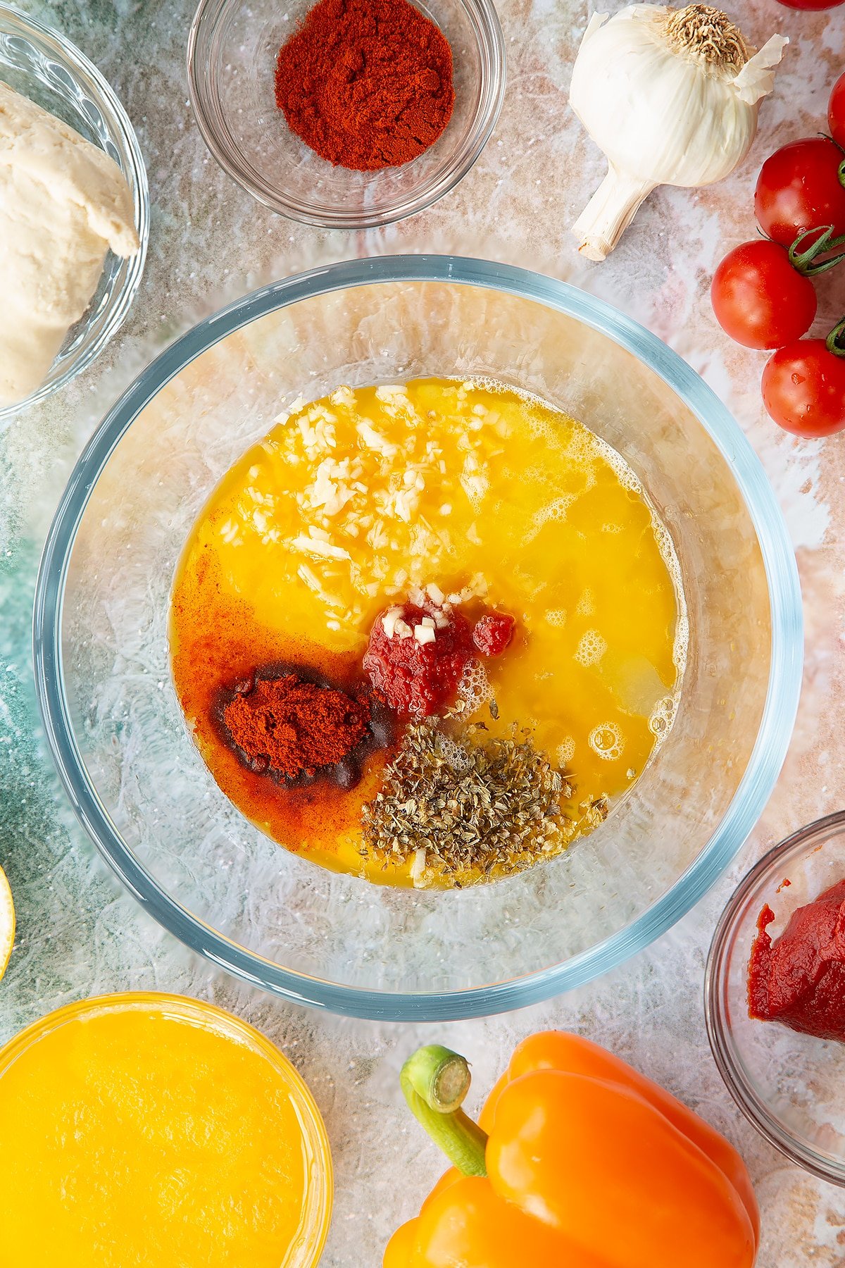 Oregano, paprika, tomato puree, garlic, lemon juice, honey, melted butter, salt and pepper in a small bowl