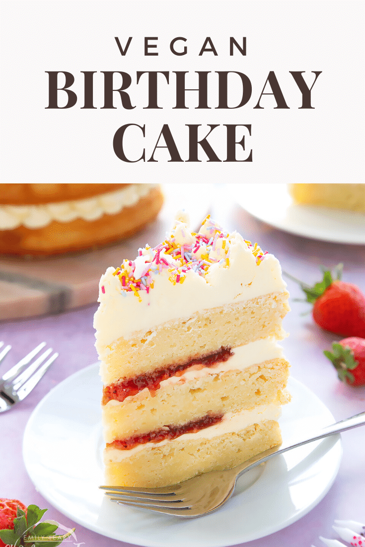 Slice of vegan birthday cake on a small white plate with a fork. Caption reads: Vegan birthday cake.