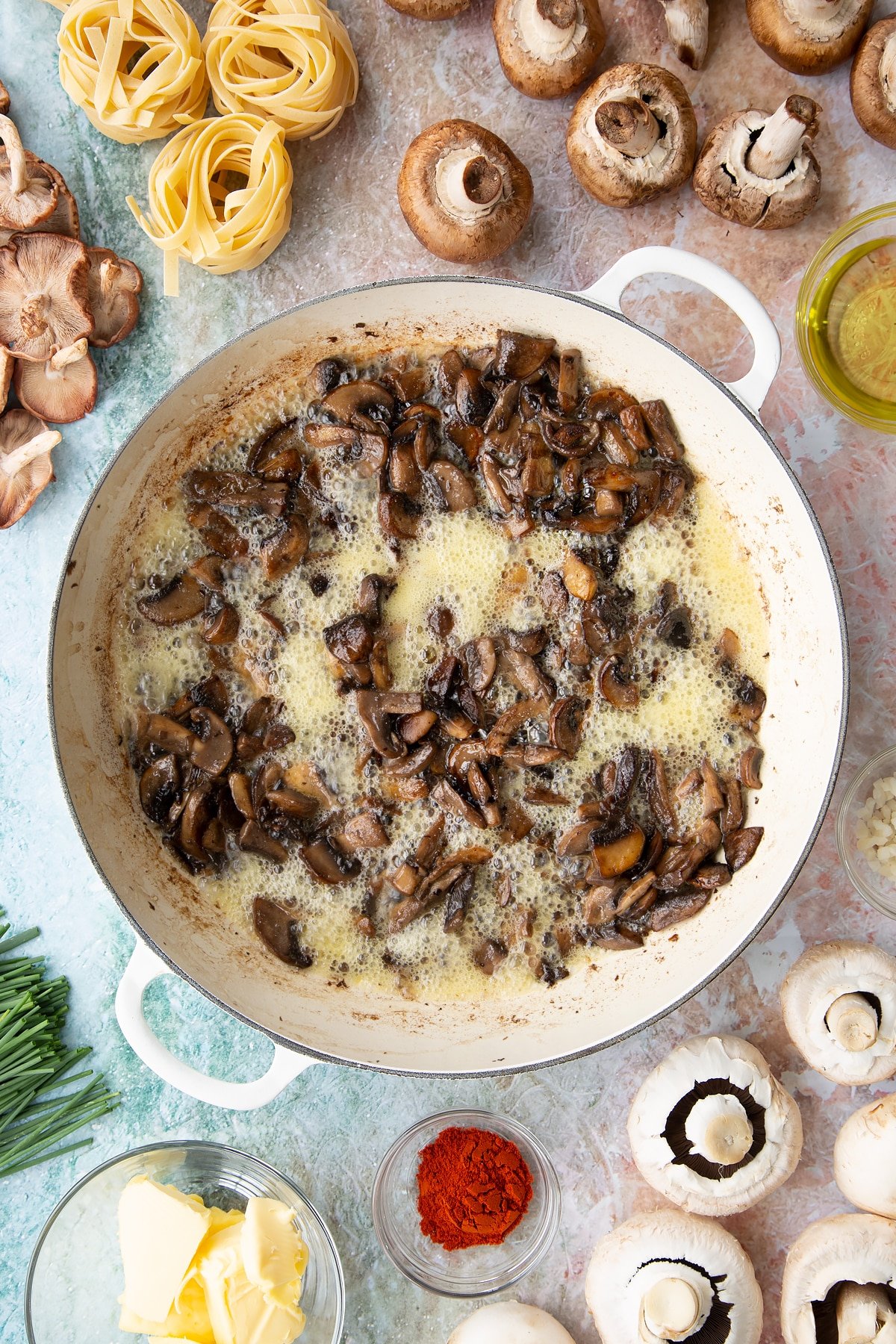 sauteed mushrroms in butter, wine and garlic until bubbling in a large white pan.