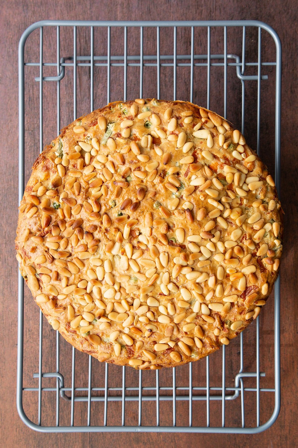 Freshly baked vegetable cake cooling on a wire rack.