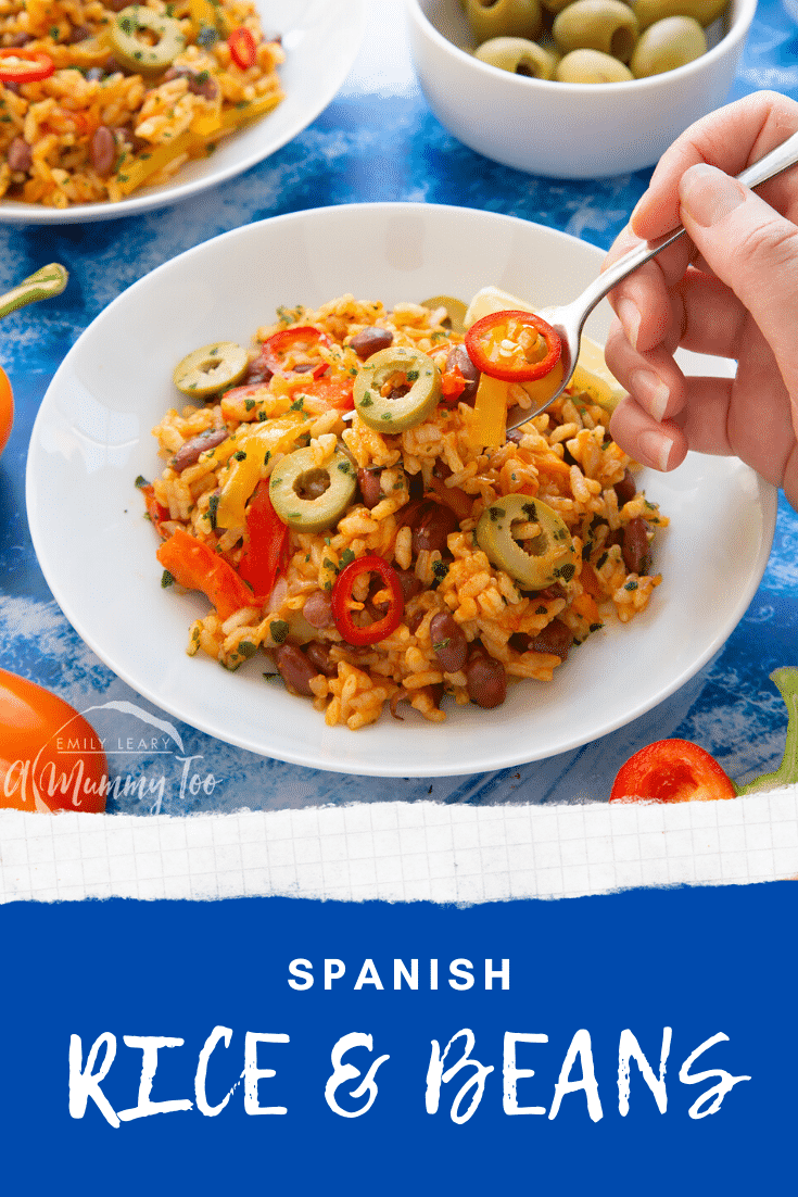 Easy Spanish rice and beans served in a shallow white bowl with a fork digging in. Caption reads: Spanish rice and beans