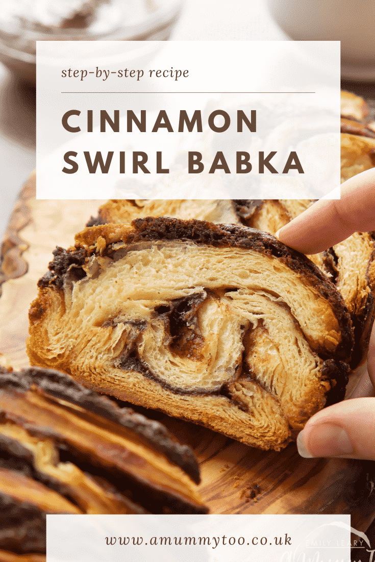 Hand reaching for a slice of cinnamon swirl babka on a wooden board. Caption reads: step-by-step recipe cinnamon swirl babka