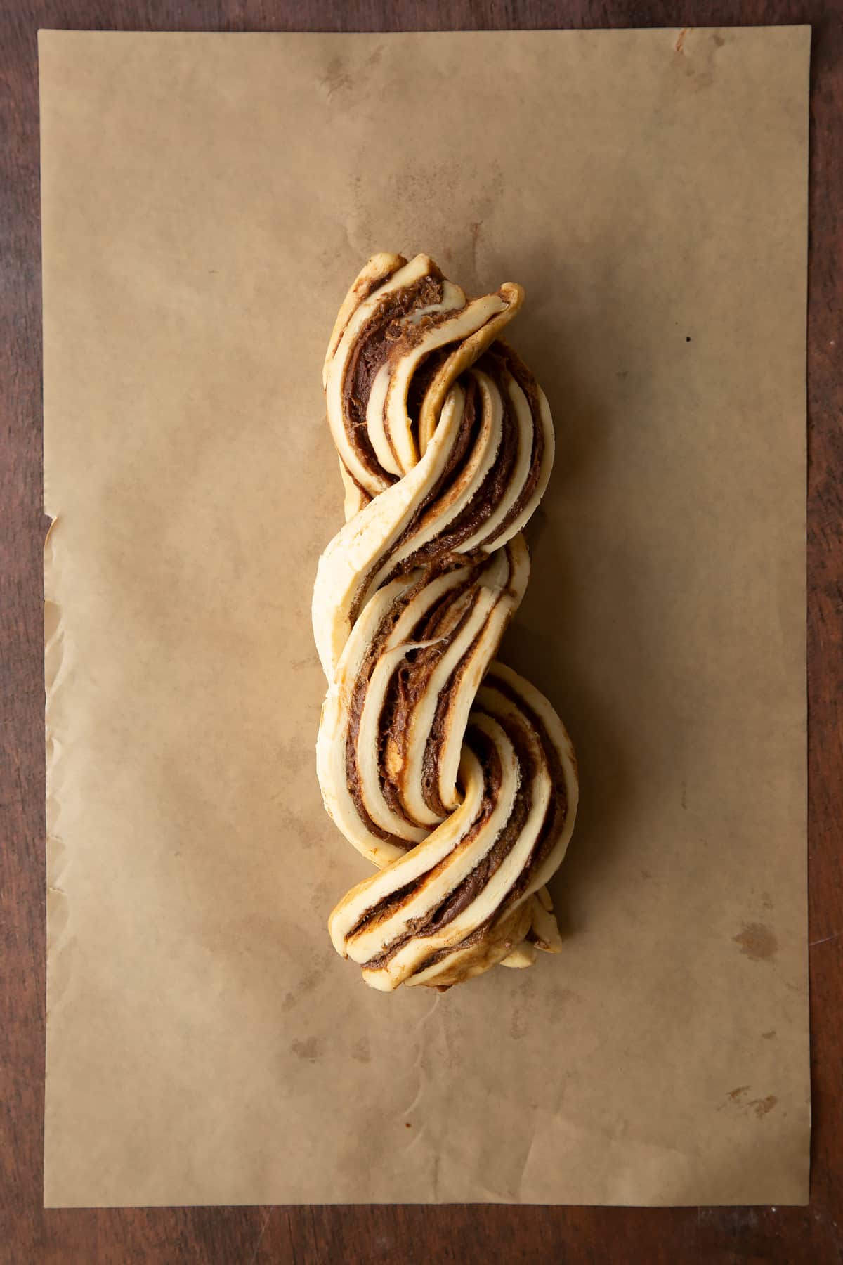 Cinnamon swirl dough rolled along the length to create a long sausage, then sliced down the length. The two striped pieces are then twisted together.