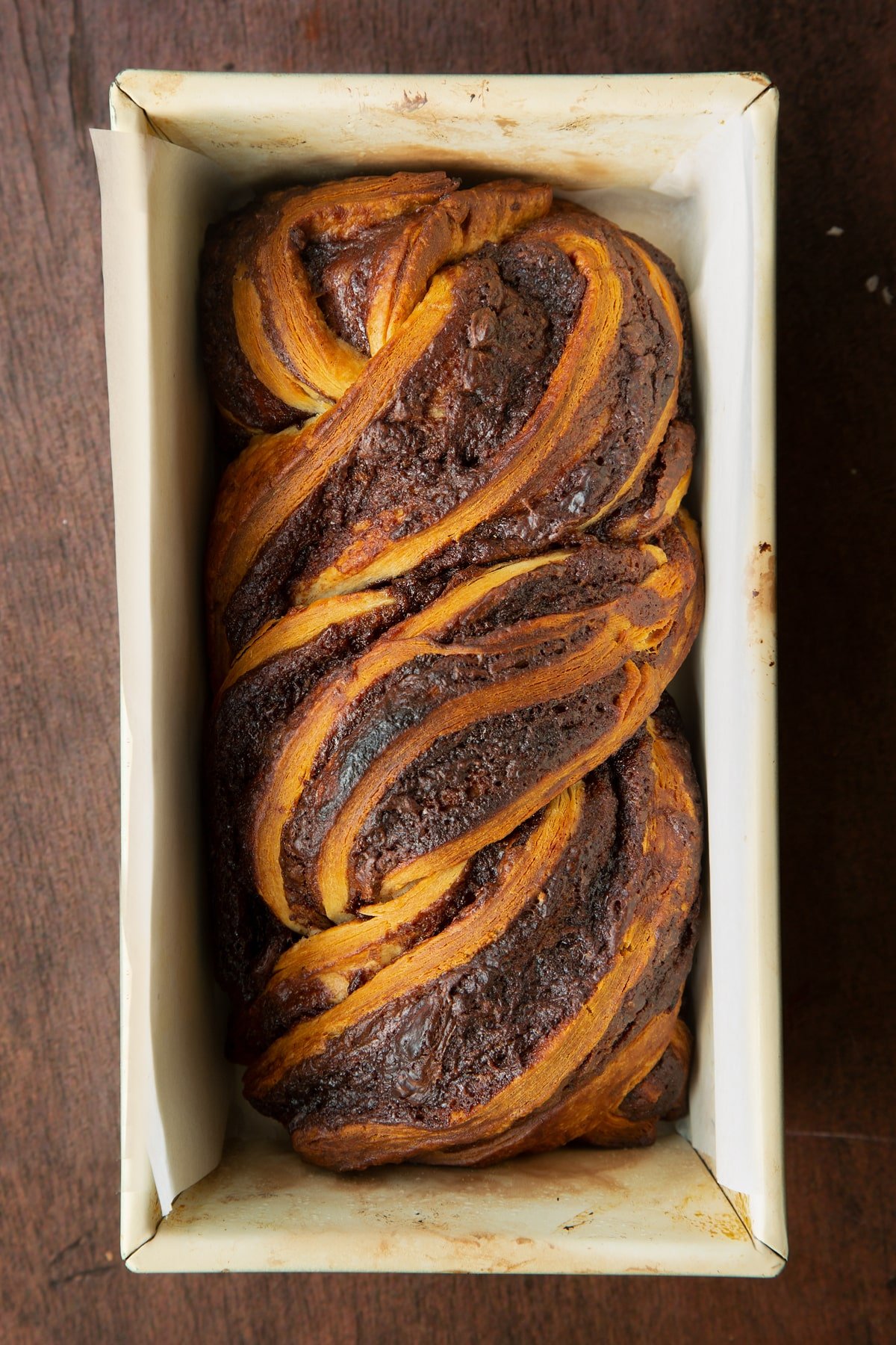 Baked cinnamon swirl babka in a lined baking tin.