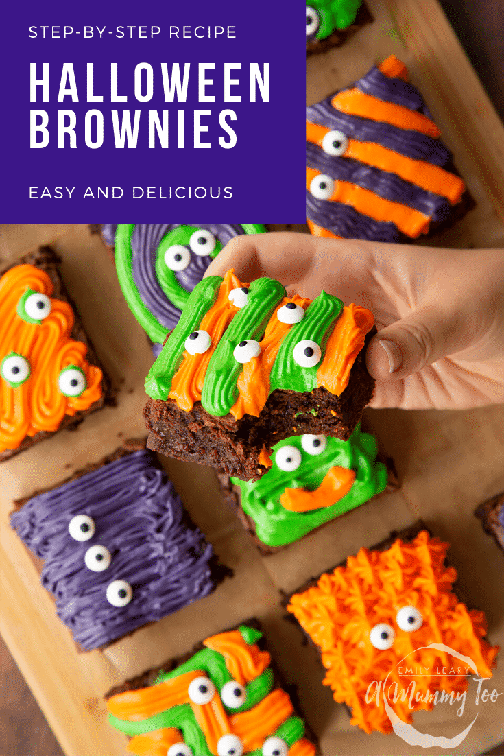 Halloween brownies arranged on a board lined with baking paper. A hand holds a purple and green frosted brownie with candy eyes. Caption reads: step-by-step recipe Halloween brownies easy and delicious