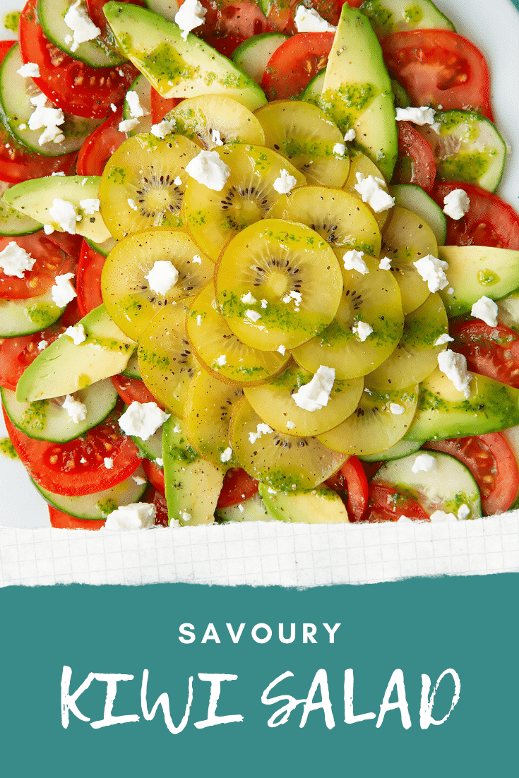 Close up from above of a kiwi feta salad on an oval white platter. Caption reads: Savoury kiwi salad.