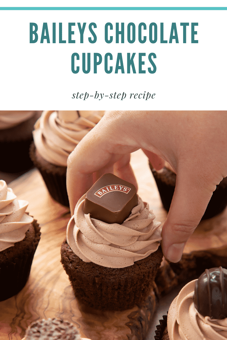 Hand reaching for a Baileys chocolate cupcake on a board. Caption reads: Baileys chocolate cupcakes. Step-by-step recipe.